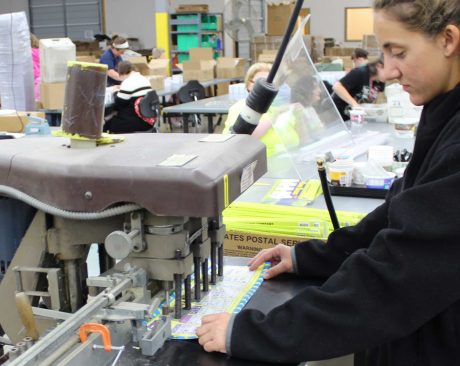 woman working on a three hole drill machine