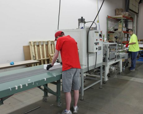 workers at the labeling machine