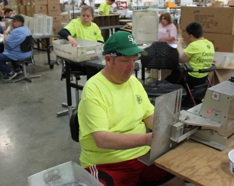 Man in a green heartland shirt working